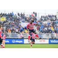 Atlético Ottawa forward Kévin dos Santos goes high for a header