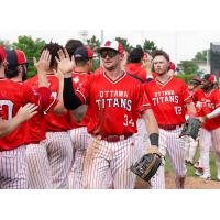 Ottawa Titans outfielder Jake Sanford exchanges high fives