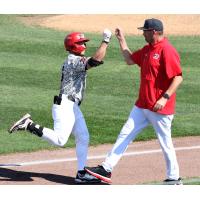 Henry George of the Sioux City Explorers celebrates with Manager Steve Montgomery