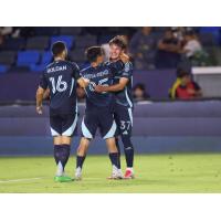 Sounders FC congratulate Snyder Brunell (far right) after his goal