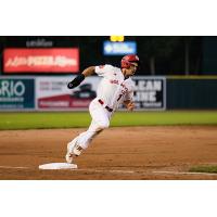 Jacob Robson of the Winnipeg Goldeyes flies around third