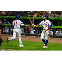 Knoxville Smokies second baseman Carter Trice (right) greets shortstop Jefferson Rojas