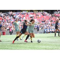 Ottawa Rapid FC and Vancouver Rise FC battle for the ball