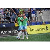 Danny Musovski of Sounders FC (right) following one of his goals