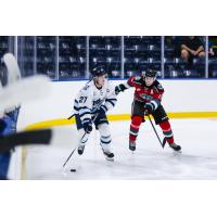 Penticton Vees right wing Corban Almen (left) vs. the Kelowna Rockets