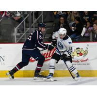Wenatchee Wild forward Miles Cooper (right) battles for the puck