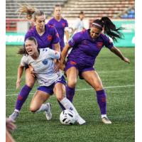 Calgary Wild FC fight to take the ball against Ottawa Rapid FC