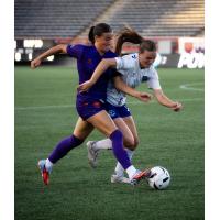 Calgary Wild FC battle for the ball against Ottawa Rapid FC