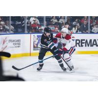 Kelowna Rockets' Eli Barrett battles Spokane Chiefs' Owen Schoettler
