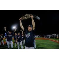 Kane County Cougars hold a championship belt aloft