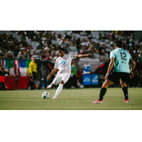 Phoenix Rising's Noble Okello and New Mexico United's Talen Maples in action