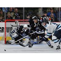 Wenatchee Wild forward Luka Shcherbyna (foreground, 27) helps to guard the net