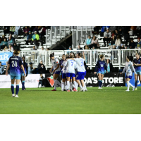Ottawa Rapid FC exchange congratulations following a goal