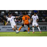Louisville City FC's Aiden McFadden and Adrien Perez and Orange County SC's Tristan Trager on game night