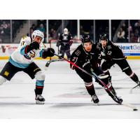 Red Deer Rebels forward Beckett Hamilton (center) and Ty Coupland (right)