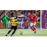 Pittsburgh Riverhounds SC's Charles Ahl and Phoenix Rising's Ascel Essengue on game night