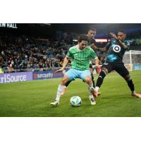 Sounders FC attemtpt to keep Minnesota United FC from the ball