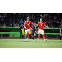 Phoenix Rising's Ryan Flood and Rafael Czichos and El Paso Locomotive FC's Amando Moreno on the field