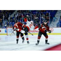Vancouver Giants right wing Ty Halaburda and defenceman Colton Alain (far right) deliver a blow