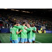 Sounders FC huddles after a goal against Minnesota United FC