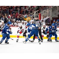 Syracuse Crunch center Conor Geekie (center) vs. the Charlotte Checkers