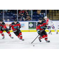 Kelowna Rockets' Gabriel O'Brien, Kalder Varga, and Jacob Henderson and Spokane Chiefs' Tristen Buckley on the ice