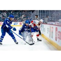 Syracuse Crunch defenseman Simon Lundmark (left) and right wing Ethan Gauthier vs. the Laval Rocket