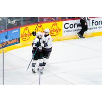 Kelowna Rockets exchange congratulations following a goal