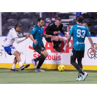 An official hops out of the way as the St. Louis Ambush battle the Kansas City Comets