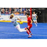 St. Louis Ambush midfielder Riley Urie gets hit in the back against the Kansas City Comets