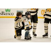 Wheeling Nailers help a young fan on skates