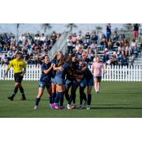 Seattle Reign FC mobs Nerilia Mondesir after her goal against Angel City FC
