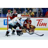 Vancouver Giants' Ethan Mittelsteadt and Kelton Pyne battle Portland Winterhawks' Nathan Brown