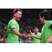 Sounders FC exchange congratulations following a goal