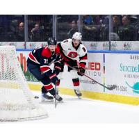 Saginaw Spirit left wing Dimian Zhilkin (left) vs. the Ottawa 67's