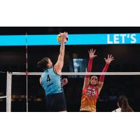 Grand Rapids Rise setter Camryn Turner (right) goes high for a block against the Orlando Valkyries