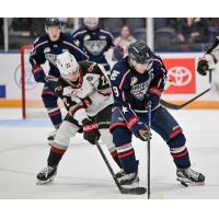 Vancouver Giants right wing Joe Iginla (left) fights for the puck vs. the Tri-City Americans