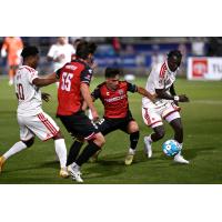 Phoenix Rising's Hope Avayevu and Jean-Eric Moursou battle San Antonio FC's Dmitrii Erofeev and Cristian Parano