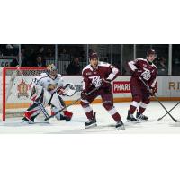 Peterborough Petes right wing Matthew Soto (center) and centre Aiden Young vs. the Barrie Colts