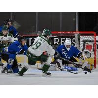 Everett Silvertips' Zackary Shantz battles Wenatchee Wild's Mathias Silaban and Carsten Leyerzapf