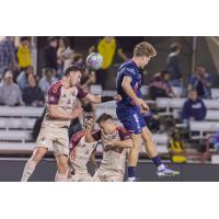 Detroit City FC goes high for a ball at Indy Eleven