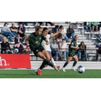 Racing Louisville FC and Seattle Reign FC in action