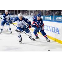 Syracuse Crunch defenseman Maxim Groshev (left) vs. the Rochester Americans