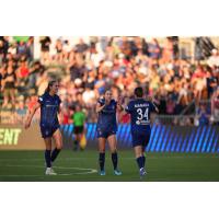 Ashley Sanchez (middle) and Manaka Matsukubo (right) of the North Carolina Courage celebrate after a goal