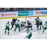 Kelowna Rockets fight for the puck in front of the Everett Silvertips net