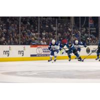 Syracuse Crunch forward Gabriel Szturc (left) eyes the puck against the Cleveland Monsters