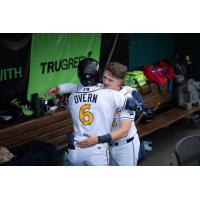 Austin Overn of the Montgomery Biscuits is greeted in the dugout
