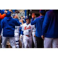 A.J. Ewing is congratulated in the Syracuse Mets dugout