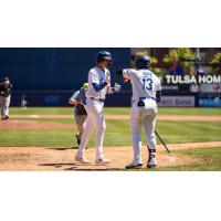 Kyle Nevin of the Tulsa Drillers (right) high fives Zyhir Hope