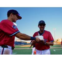 Pensacola Blue Wahoos present Manager Nelson Prada a cake after his 800th victory